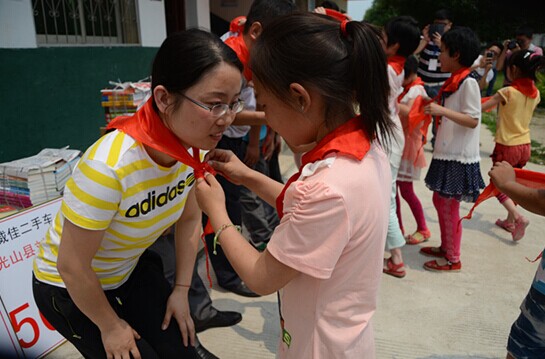 捐贈儀式上，孩子們?yōu)閻坌奶焓瓜瞪霞t領(lǐng)巾