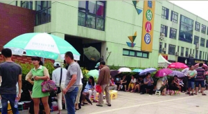 金壇市實(shí)驗(yàn)幼兒園門前，家長(zhǎng)在排隊(duì)