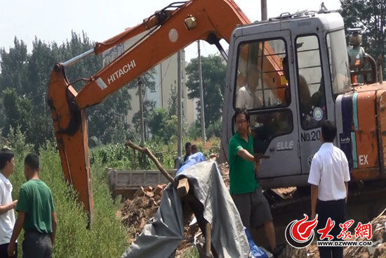 陳寶成手持自制刀斧守在挖掘機(jī)旁阻止便衣民警靠前。（視頻截圖）
