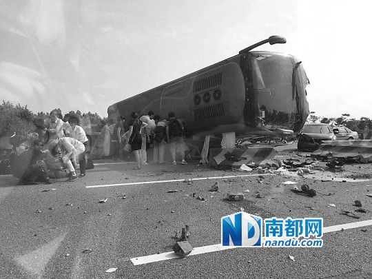 現(xiàn)場大客車側(cè)翻，玻璃碎落一地，車身卡在路邊水泥護欄上。 目擊者供圖