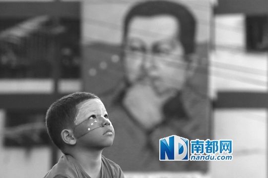 3月5日，一名委內(nèi)瑞拉兒童仰望天空，他身后是查韋斯的陵墓。