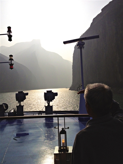 　　游客在游輪上遠(yuǎn)眺三峽風(fēng)光。