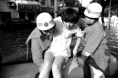 10月10日，前來余姚支援的杭州消防支隊武警官兵在南西路幫助轉(zhuǎn)移被困群眾。新華社發(fā)