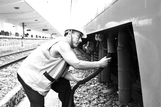 昨日，商丘火車站給水員在烈日下工作