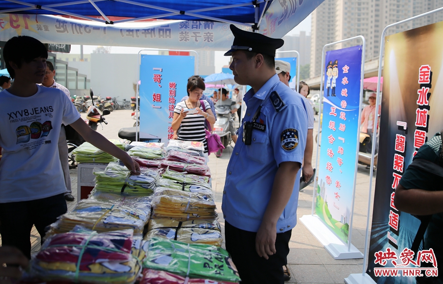 執(zhí)法人員勸導(dǎo)看守?cái)偽坏娜藛T搬離，停止非法占道經(jīng)營(yíng)。