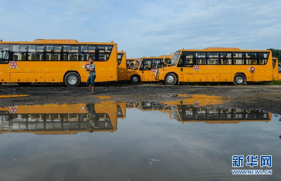 8月29日，溫嶺市城西街道芷勝莊村一名小男孩從閑置的校車邊走過。